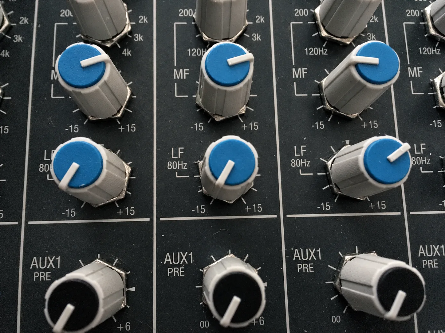 Blue equalizer knobs on the mixing console